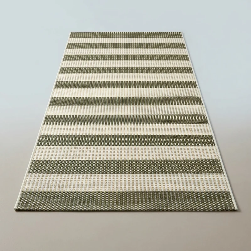 OJIA striped woven washable door mat at an entryway